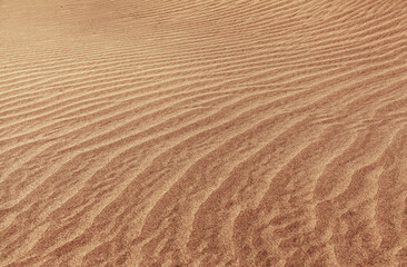 natural sand pattern created by wind blowing differently sized and colored particles