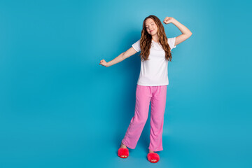 Photo of adorable lovely cute girl waking up stylish pajama empty space isolated on blue color...