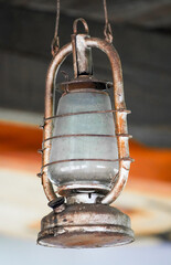 Old hanging metal oil lamp close-up.
