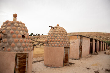 Rustic bee hives made of mud, in modern days it is supported with cement for birds to live in with...