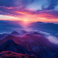 Obraz premium A majestic sunrise over a mountain range with colorful skies and misty valleys
