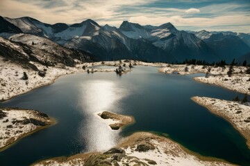 Snow-Capped Mountain Lake with Reflective Waters: Serene Alpine Landscape