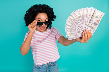 Photo portrait of lovely young lady hold money fan dressed stylish striped garment isolated on...