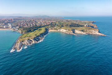 A bird-eye view of the city of Santander from the ocean. Blue water, blue sky