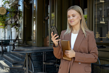 A girl in a business suit with a phone.