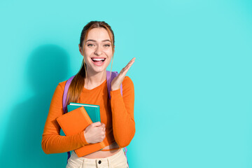 Photo of impressed girl with ginger hair dressed orange shirt backpack hold books raising palm...