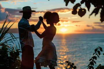 Fototapeta premium Silhouette of a couple dancing at the beach during a stunning sunset