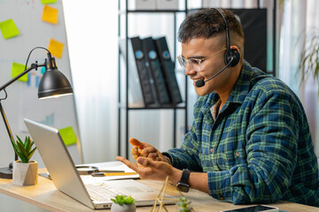 Hindu business man wearing headset freelance worker call center or support service operator...