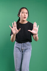 Serious woman showing cross hands gesture, demonstrating denial sign, rejecting something unwanted.