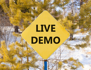 Live demo symbol. Concept words Live demo on beautiful yellow road sign. Beautiful forest snow blue...