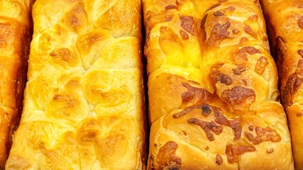 Freshly baked loaves of cheese bread in small artisanal bakery. Crust and use of fresh, local...