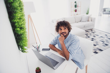 Photo of thoughtful good mood man wear checkered shirt texting modern gadget indoors house...