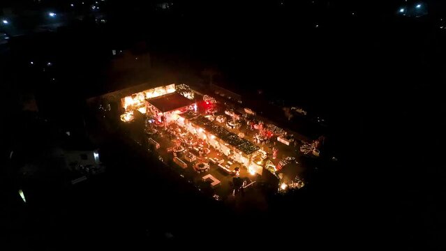 Drone shot of wedding night party decorated with beautiful lights.