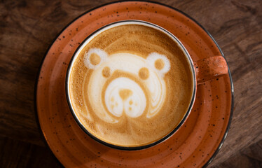 Cappuccino foam art concept. Bear shaped figure made with foam milk on cappuccino drink.
