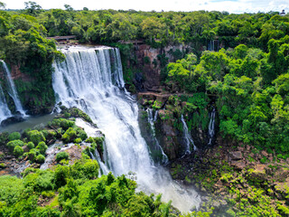 Top down aerial view of the picturesque Iguazu (Iguacu) Falls on the border of Brazil and Argentina in a national park surrounded by tropical forest and trees. Drone shooting