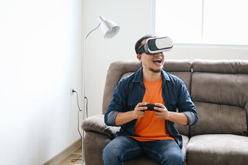 Man Using VR Glasses to Play Virtual Games and Joystick at Living Room