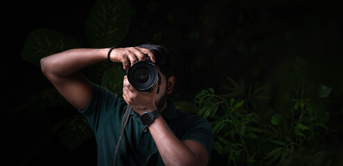 Photographer with professional camera and taking picture of nature, Website banner type image of...