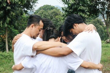 Group of People Bonding in Circle and Hug Each Other Outdoors