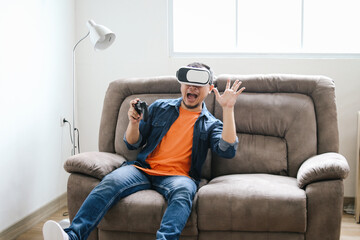 Man Using VR Glasses to Play Virtual Games and Joystick at Living Room