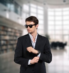 Smiling professional business man standing in office