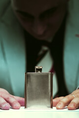 Flask symbolizes struggle against harmful alcohol dependency