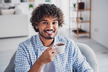 Photo of cool good mood man wear checkered shirt staying home enjoying coffee indoors house...