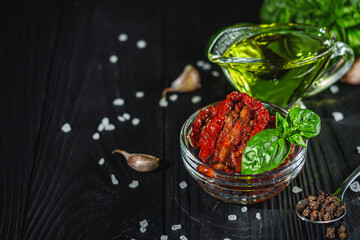 fresh sun-dried tomatoes on a black wooden rustic background