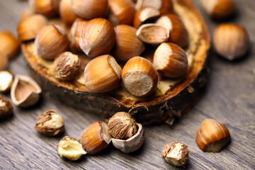 Close-up. Hazelnuts in shell and without on a wooden stand.