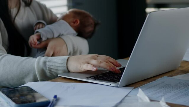 A young woman with a child. Single mother with online job search, child care or loan research and kid sleeping.
