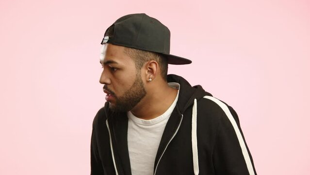 An African American man appears disconcerted and confused, his brows furrowed in a gesture of bewilderment as he processes the situation before him. Camera 8K RAW. 