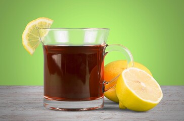 Tasty hot herbal tea in cup with lemon