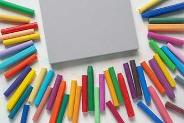 Sketchbook and colorful oil pastel crayons. Free space for text or image
