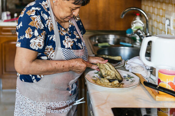 Senior woman preparing food in the kitchen
