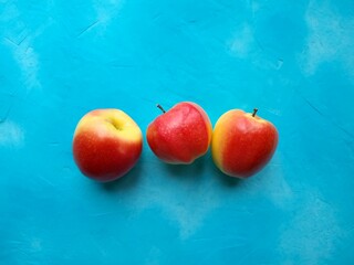 Red apples on blue background