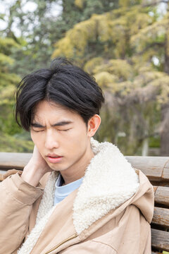 Young man experiencing discomfort, possibly hypoglycemia