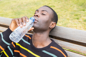 Man drinking water to manage dehydration symptoms