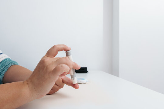 Person checking blood sugar level with glucose meter