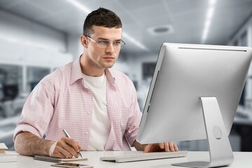 Happy business person typing on computer in office
