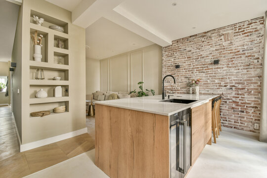 Modern kitchen with wooden cabinets and brick wall