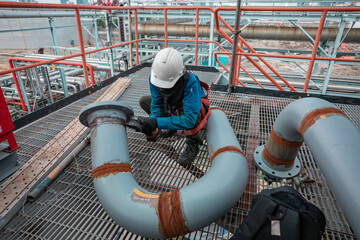 Male worker inspection at steel long pipes and pipe elbow in station oil factory during refinery...