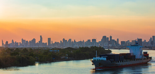 Cityscape at view evening from the river cargo container import container ship in the international...
