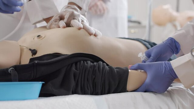 CPR training. The doctor injects the medicine into the patient's vein