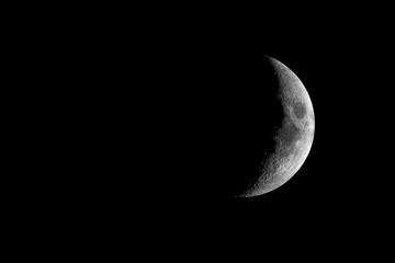Detailed white Crescent Moon in night sky.