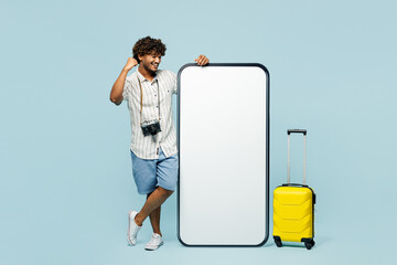 Traveler man wear white casual clothes big blank screen mobile cell phone do winner gesture...