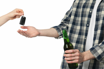 Woman giving car keys to man with bottle of beer on white background, closeup. Don't drink and...