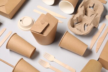 Eco friendly food packaging. Paper containers and tableware on light grey background