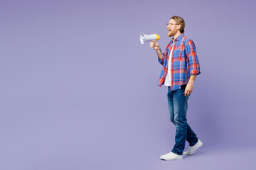 Full body sideways young happy man wear blue shirt casual clothes hold in hand megaphone scream announces discounts sale Hurry up isolated on plain pastel light purple background. Lifestyle concept