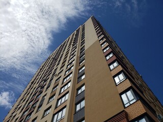 high-rise building against the blue sky. Low angle shooting