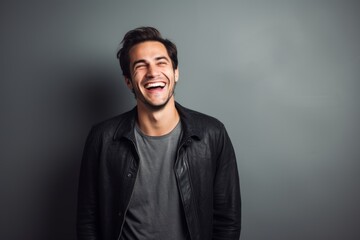 Fototapeta premium Portrait of a grinning man in his 30s laughing isolated on minimalist or empty room background