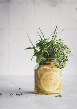 Infused Water with Lemons and Fresh Herbs in a Jar